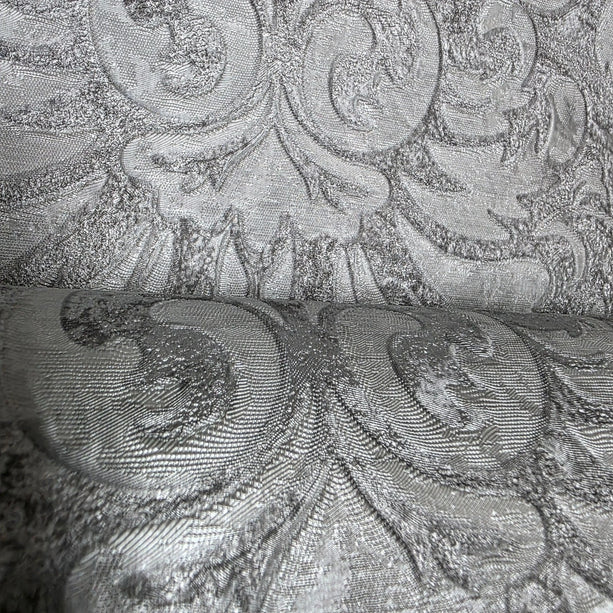 Close-up of textured fabric with intricate patterns in gray tones
